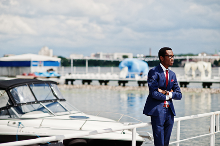 African american happy successful man at suit against yacht. Rich black business man.の写真素材