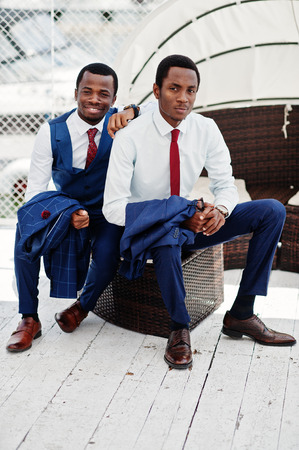 Two african american happy successful mans at suit. Rich black business mans.の写真素材