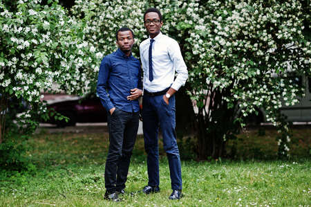 Group of two african american mans posed at street of city.の写真素材