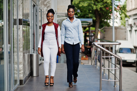 Two stylish african american girls friends posed outdoor of steets city.の写真素材