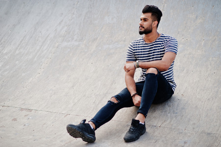 Handsome tall arabian beard man model at stripped shirt posed outdoor. Fashionable arab guy.の写真素材