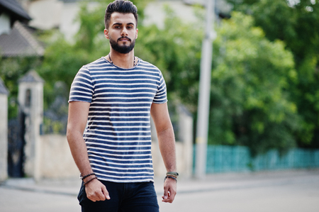 Handsome tall arabian beard man model at stripped shirt posed outdoor. Fashionable arab guy.の写真素材
