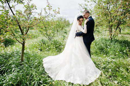 Fabulous wedding couple having their time outdoors in the garden on a special day.の写真素材