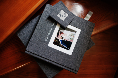 Elegant grey photo book or photo album and flash drive case on wooden stairs.の写真素材