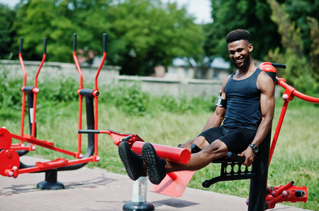 African american male athlete sport man with running sports arm case for mobile phone, doing...