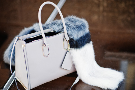 Close-up photo of a stylish bag with furry decor on top.の写真素材