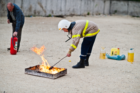 Hai, Ukraine - July 10, 2018: Tutorial how to give the fire safety, extinguish fire. Fireman hold in hand fire extinguisher. Protection from flame. Show training instructions.のeditorial素材