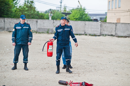 Hai, Ukraine - July 10, 2018: Tutorial how to give the fire safety, extinguish fire. Fireman hold in hand fire extinguisher. Protection from flame. Show training instructions.のeditorial素材