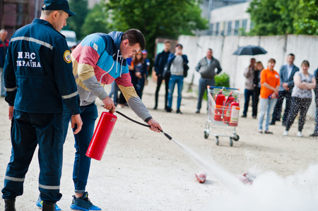 Hai, Ukraine - July 10, 2018: Tutorial how to give the fire safety, extinguish fire. Fireman hold in hand fire extinguisher. Protection from flame. Show training instructions.のeditorial素材