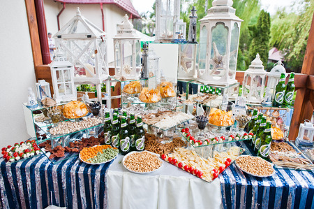 Hai, Ukraine - July 10, 2018: Catered table full of different snacks, fruits and alcohol drinks. Wedding banquet.のeditorial素材