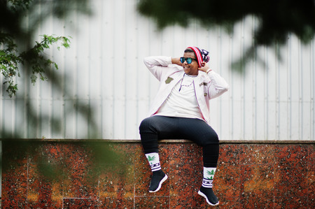 Stylish hipster arab man guy posed outdoor in street. Style rap singer.の写真素材