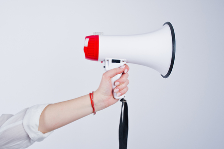 Close-up photo of the megaphone in female hand.の写真素材