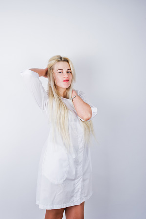 Attractive blonde female doctor or nurse  in lab coat isolated on white background.の写真素材