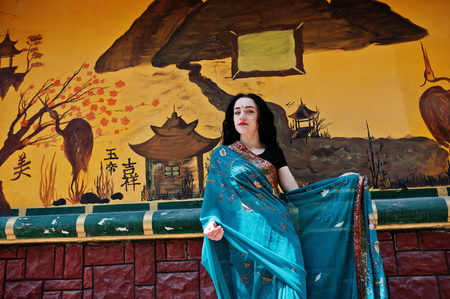 Portrait of beautiful Indian brunette girl model against Japanese traditional house.の写真素材