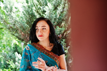 Portrait of beautiful Indian brunette girl model against Japanese traditional house.