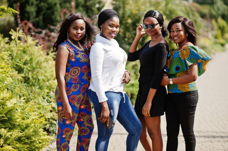 Group of four african american girls posed outdoor in good mood.