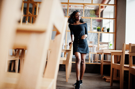 African american girl posed at wooden modern cafe.の写真素材