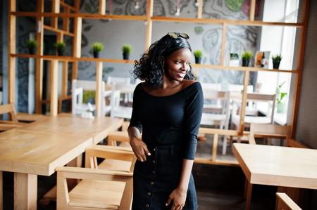 African american girl posed at wooden modern cafe.の写真素材