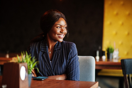 African american businesswoman sitting at table in cafe. Black girl having rest.の写真素材