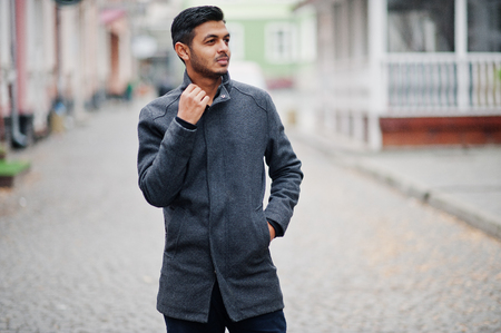 Stylish indian hindu man in gray coat posed on street.の写真素材