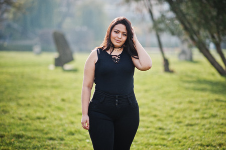 Pretty latino model girl from Ecuador wear on black posed at street.
