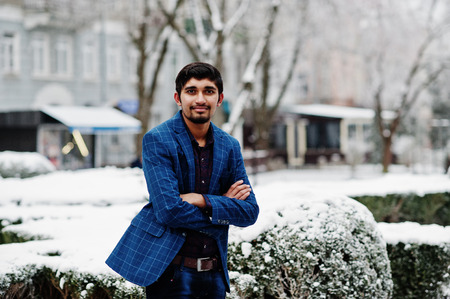Young indian man on suit posed outdoor in winter day.の写真素材