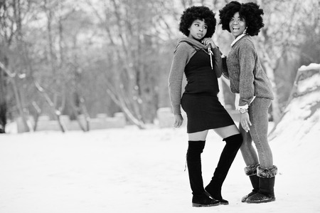 Two curly hair african american woman wear on sweaters posed at winter day.の写真素材