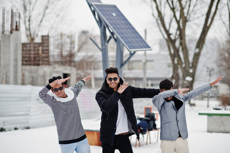 Group of three casual young indian mans in sunglasses posed at winter day, shows dab.の写真素材