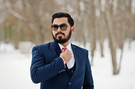 Stylish indian beard business man in suit and sunglasses posed at winter day outdoor.の写真素材
