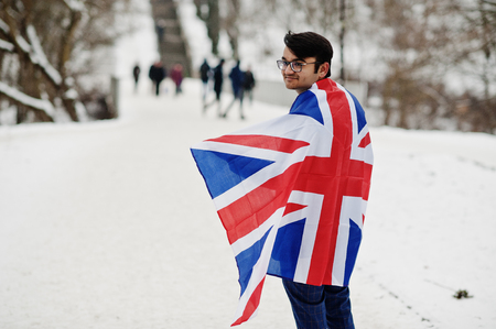Stylish indian man in suit with Great Britain flag posed at winter day outdoor.の写真素材
