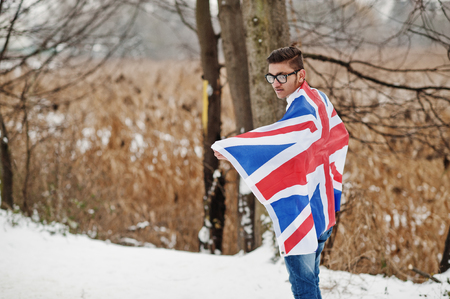 Stylish indian man in suit with Great Britain flag posed at winter day outdoor.の写真素材