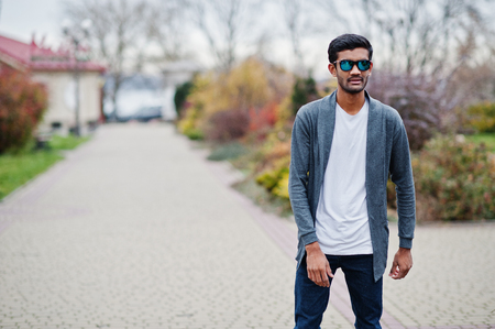 Stylish indian man at sunglasses wear casual posed outdoor.の写真素材