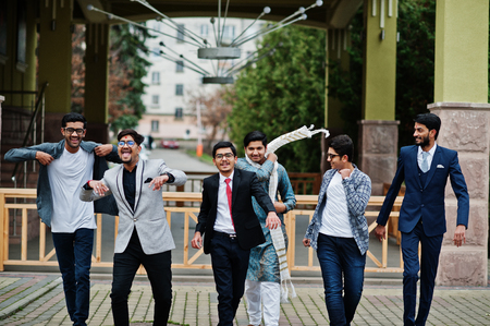 Group of six south asian indian mans in traditional, casual and business wear walking dancing and...