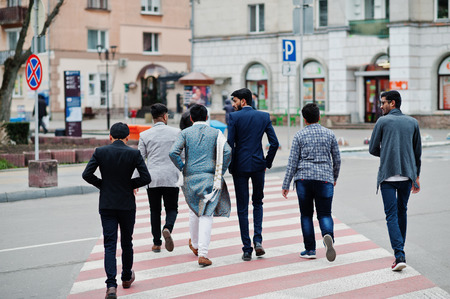 Back of group six south asian indian mans in traditional, casual and business wear walking at...
