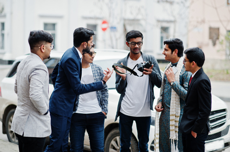 Group of six south asian indian mans in traditional, casual and business wear. Asia tourists looking at the dslr photo camera.の写真素材