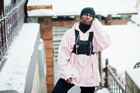 Stylish urban style african american man in pink hoodie posed at winter day.