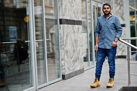 Stylish indian beard model man in casual clothes posed outdoor at street of India.の写真素材
