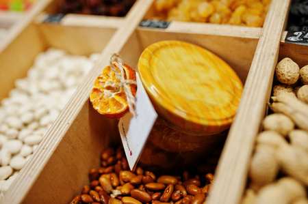 Hommemade jar with jam with nuts on the shelf of a supermarket or grocery store. Made with love.の写真素材