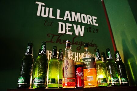 Kyiv, Ukraine - January 20, 2018: Tullamore Dew whiskey with Carlsberg beer bottles on the wooden...