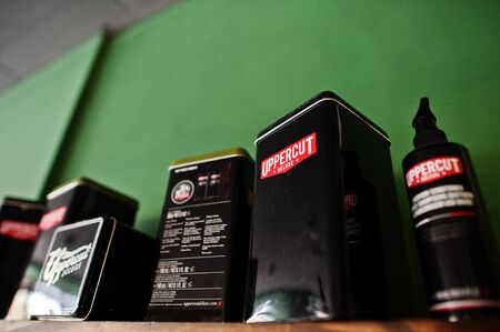 Kyiv, Ukraine - January 20, 2018: Uppercut hair products on the wooden shelf in barbershop with...