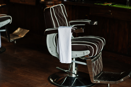 Brown vintage leather chair at stylish barber shop.の写真素材
