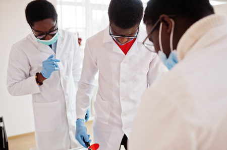 Three african american male doctors colleagues in clinic.の写真素材