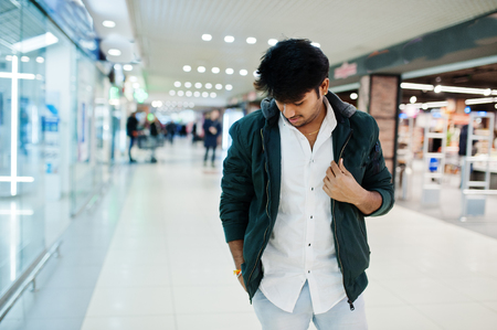 Fashionable indian guy at white shirt and jacket posed on mall. Asian man shopping.の写真素材