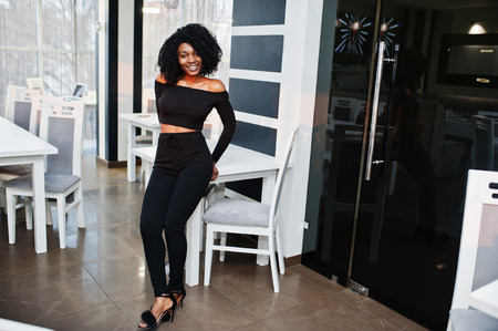 Fashionable young beautiful african american business woman with afro hairstyle wear in elegant...