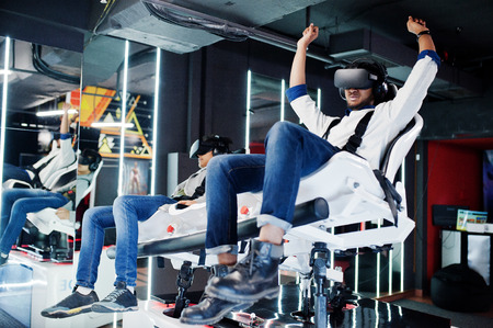 Two young indian people having fun with a new technology of a vr headset at virtual reality...