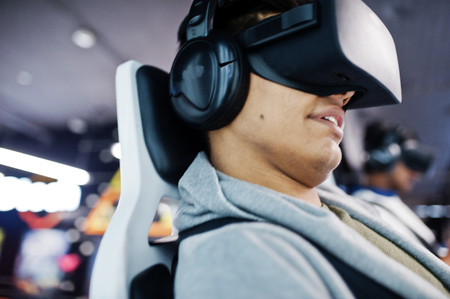 Close up face of man. Two young indian people having fun with a new technology of a vr headset at...