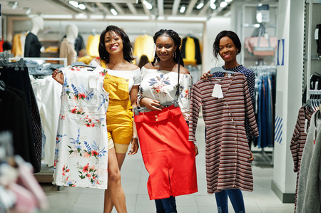 Three african woman choosing clothes at store. Shopping day.の写真素材