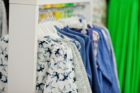 Female colorful clothing set of on the racks in clothing store brand new modern boutique.の写真素材
