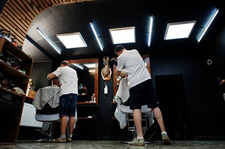 Hai, Ukraine - June 14 2019: Professional hairstylists in barbershop interior.