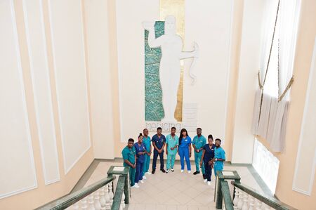 Group of african medical students in college standing on stairs.の写真素材